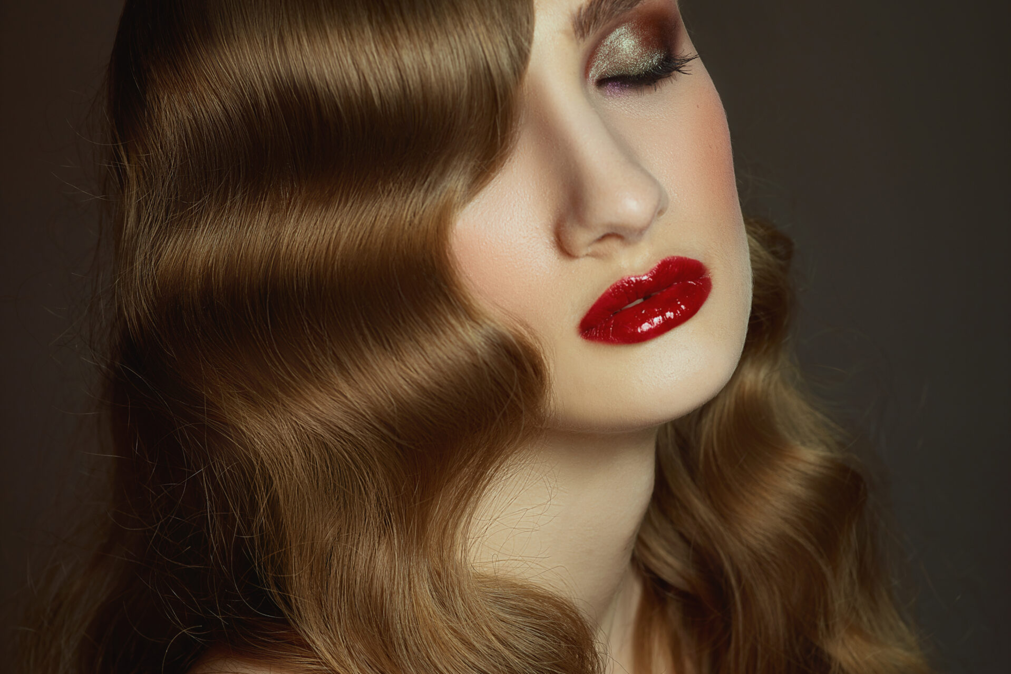 Close-up indoor portrait of lovely girl with colorful hair. Studio shot of graceful young woman with stylish haircut